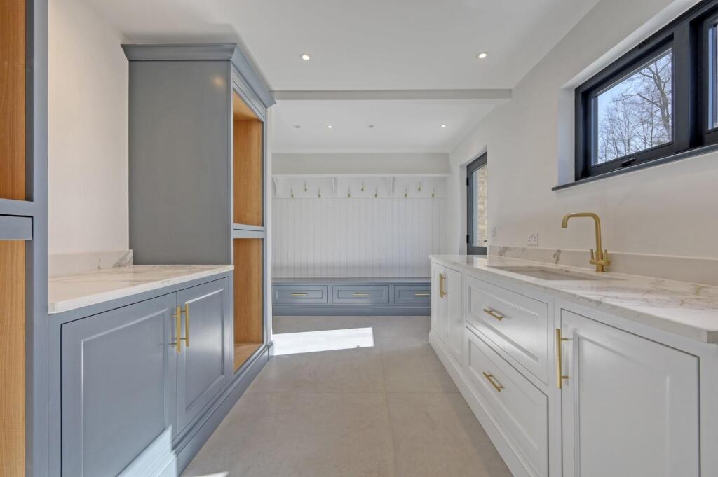 Boot-room cabinetry with a bench, drawers and coat storage