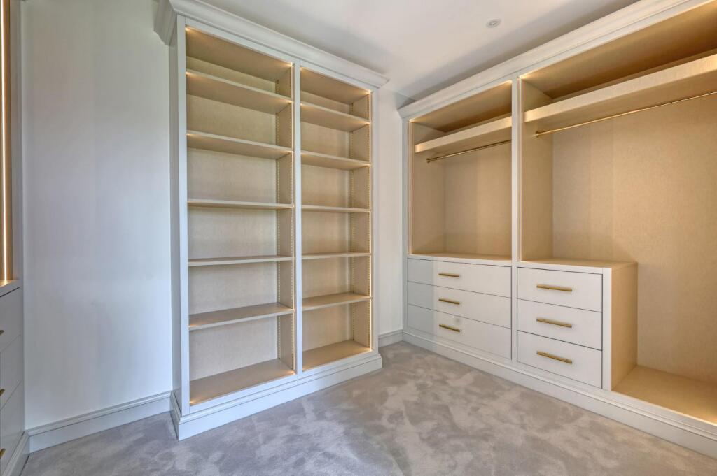 Illuminated open wardrobe shelving and hanging space