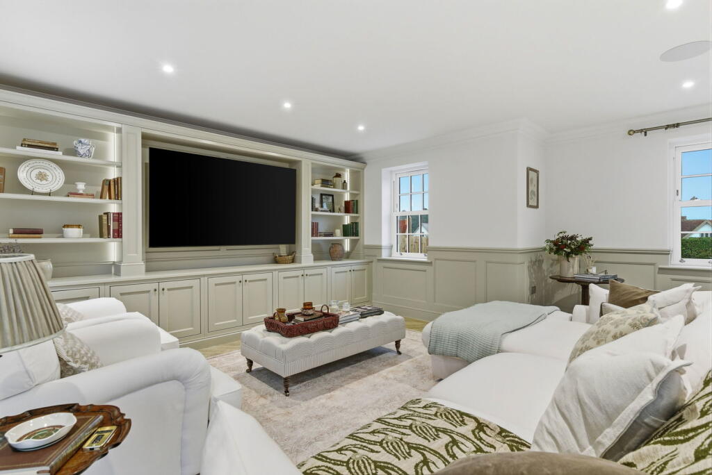 Painted media wall with library shelving and concealed storage